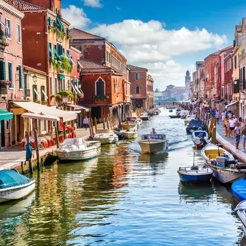 Visitors and boats in the canals of Murano Island