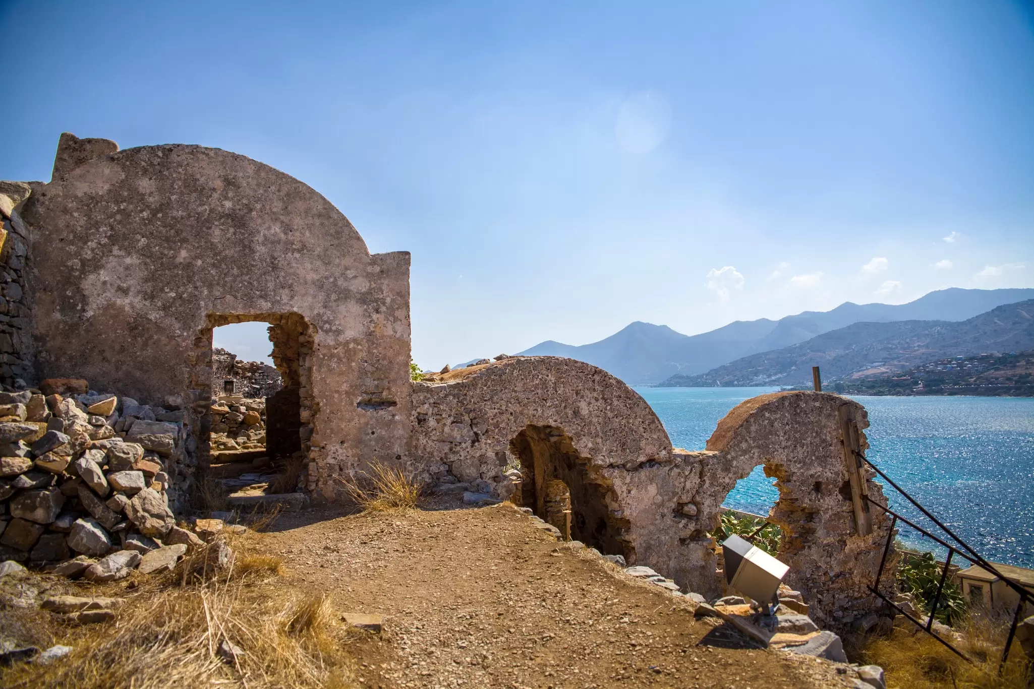 Ruins of apartments on the island of Spinalonga on a sunny day.
