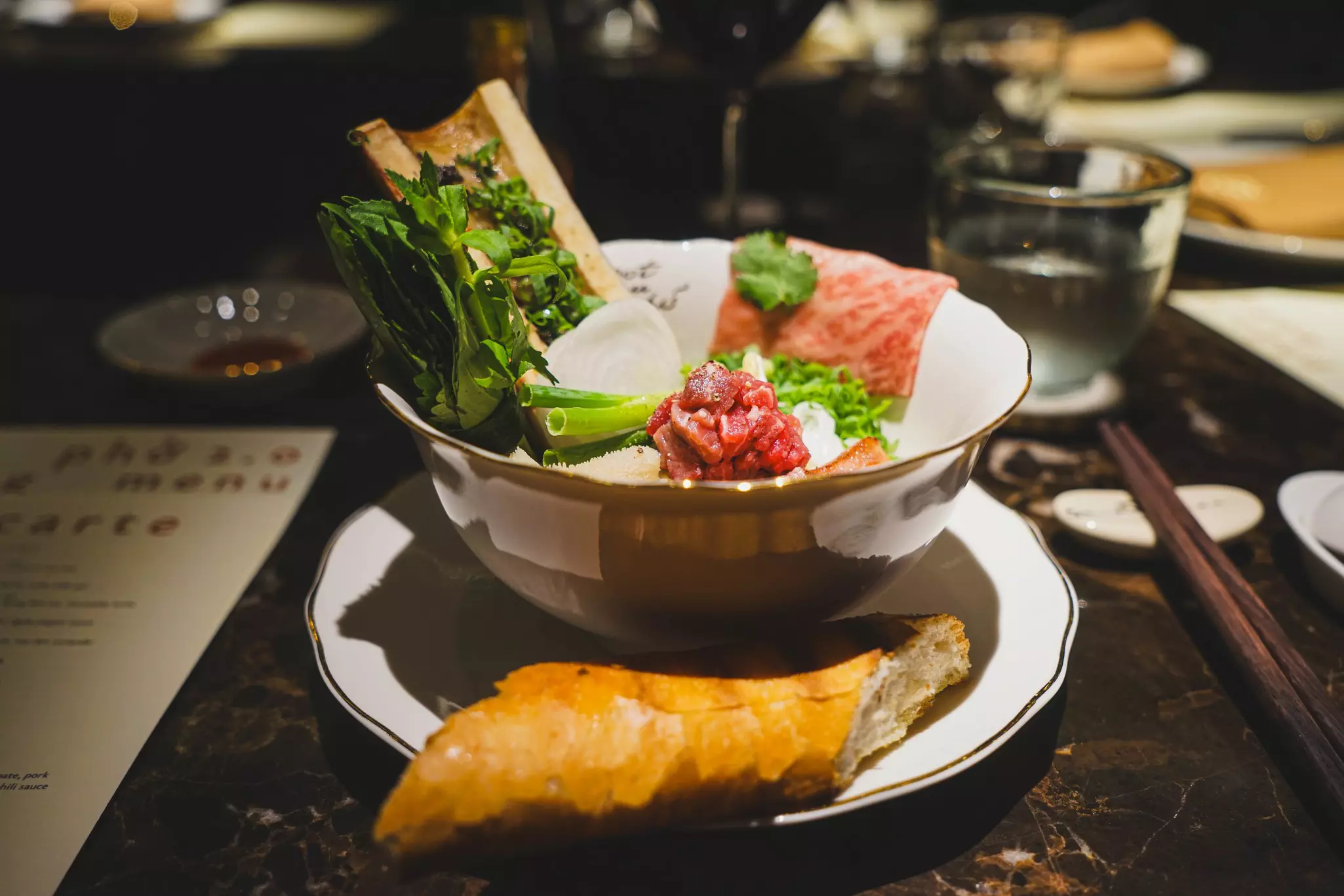 A bowl loaded with vegetables and meat served in a restaurant in HCMC, Vietnam