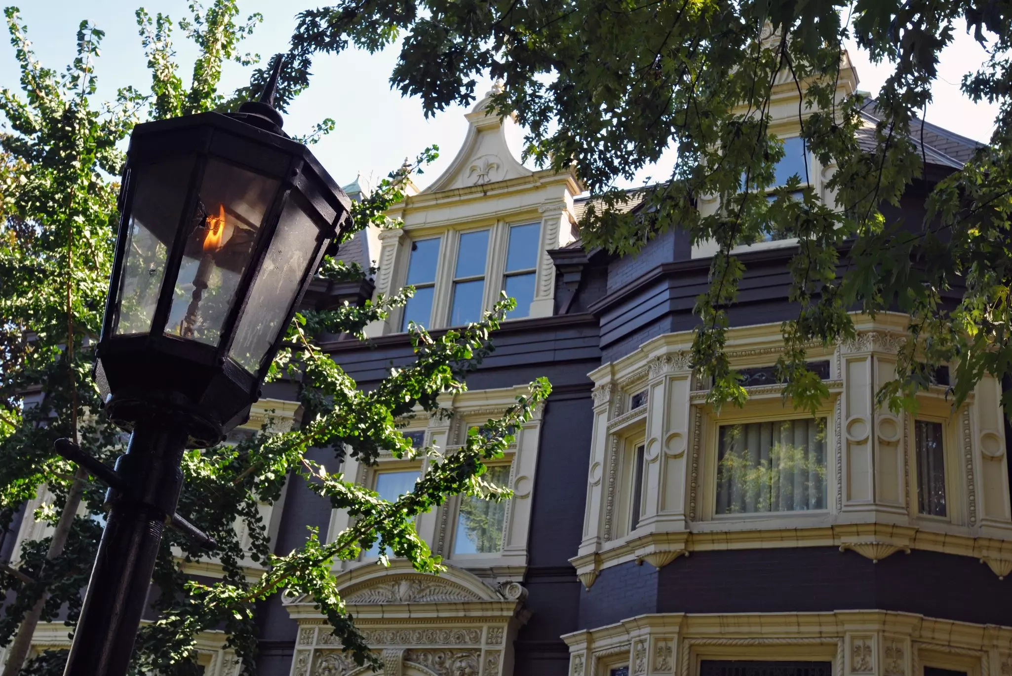 Exterior of Victorian home with gas street lamp in the foreground.