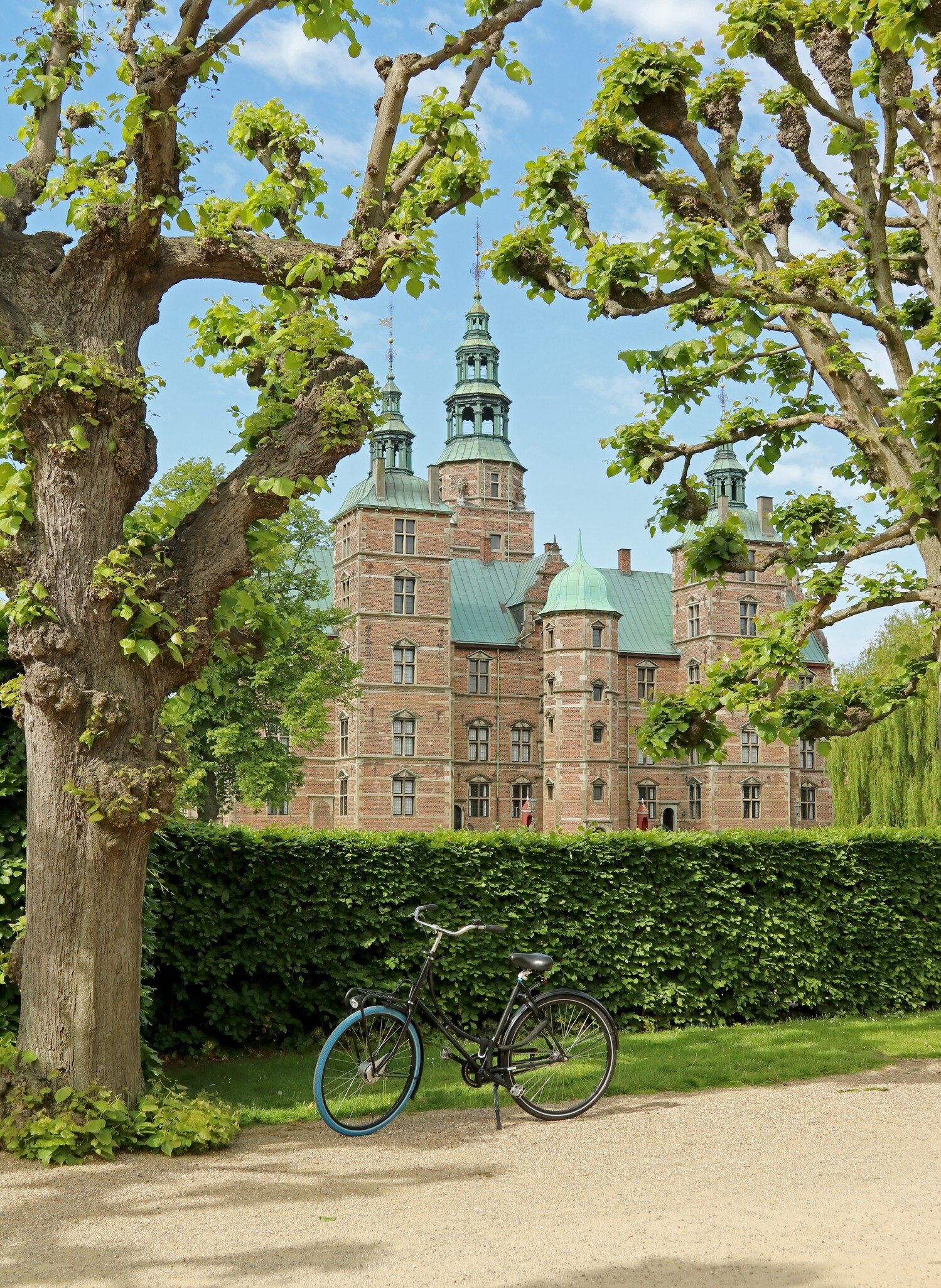 View of the Rosenborg Palace in Copenhagen, Denmark. Summer. Bicycle parked at city park in center.