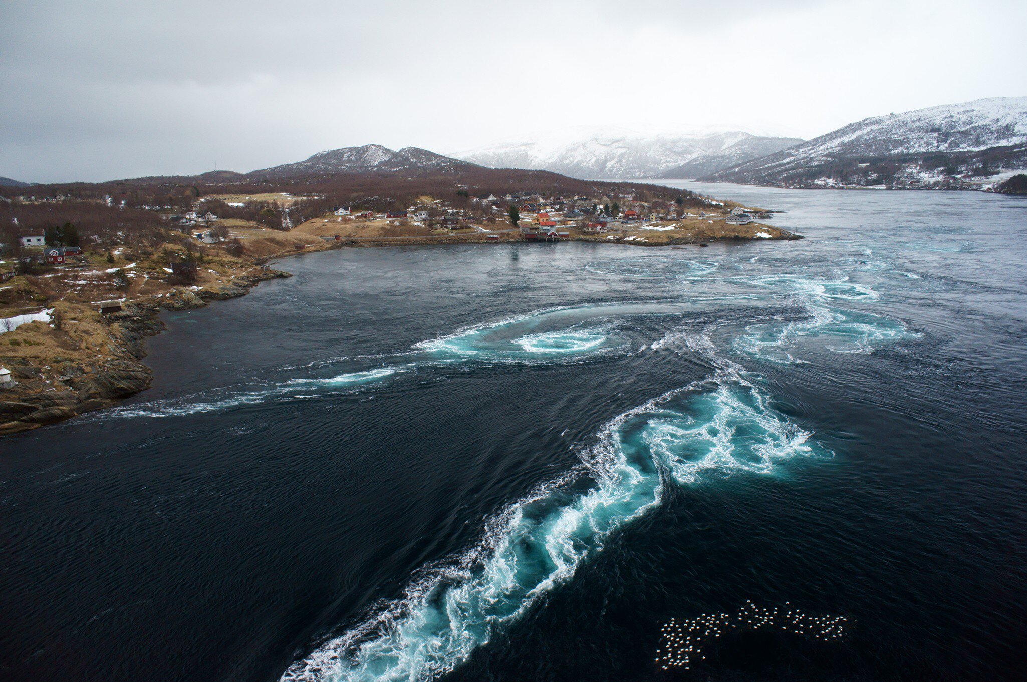 Whirlpool and Tidal Currents in the Saltstraumen Maelstrom . Violent tidal currents and a swirling vortex in the Saltstraumen strait, the largest maelstrom in the world. (Nordland, Norway)