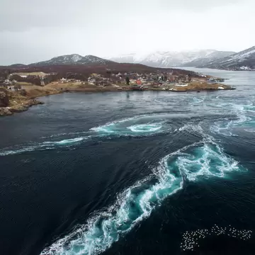 Whirlpool and Tidal Currents in the Saltstraumen Maelstrom . Violent tidal currents and a swirling vortex in the Saltstraumen strait, the largest maelstrom in the world. (Nordland, Norway)