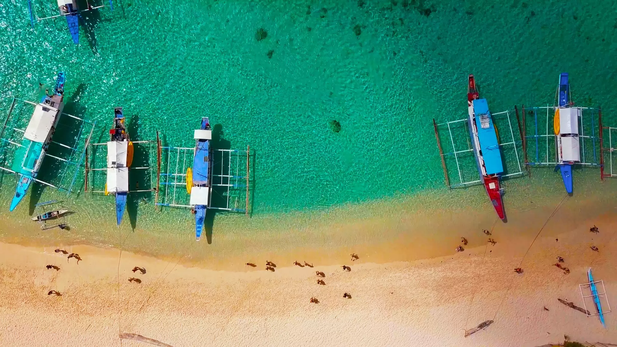 Boats sit on the shoreline on a beach in El Nido, Philippines. 