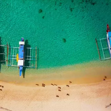 Boats sit on the shoreline on a beach in El Nido, Philippines. 