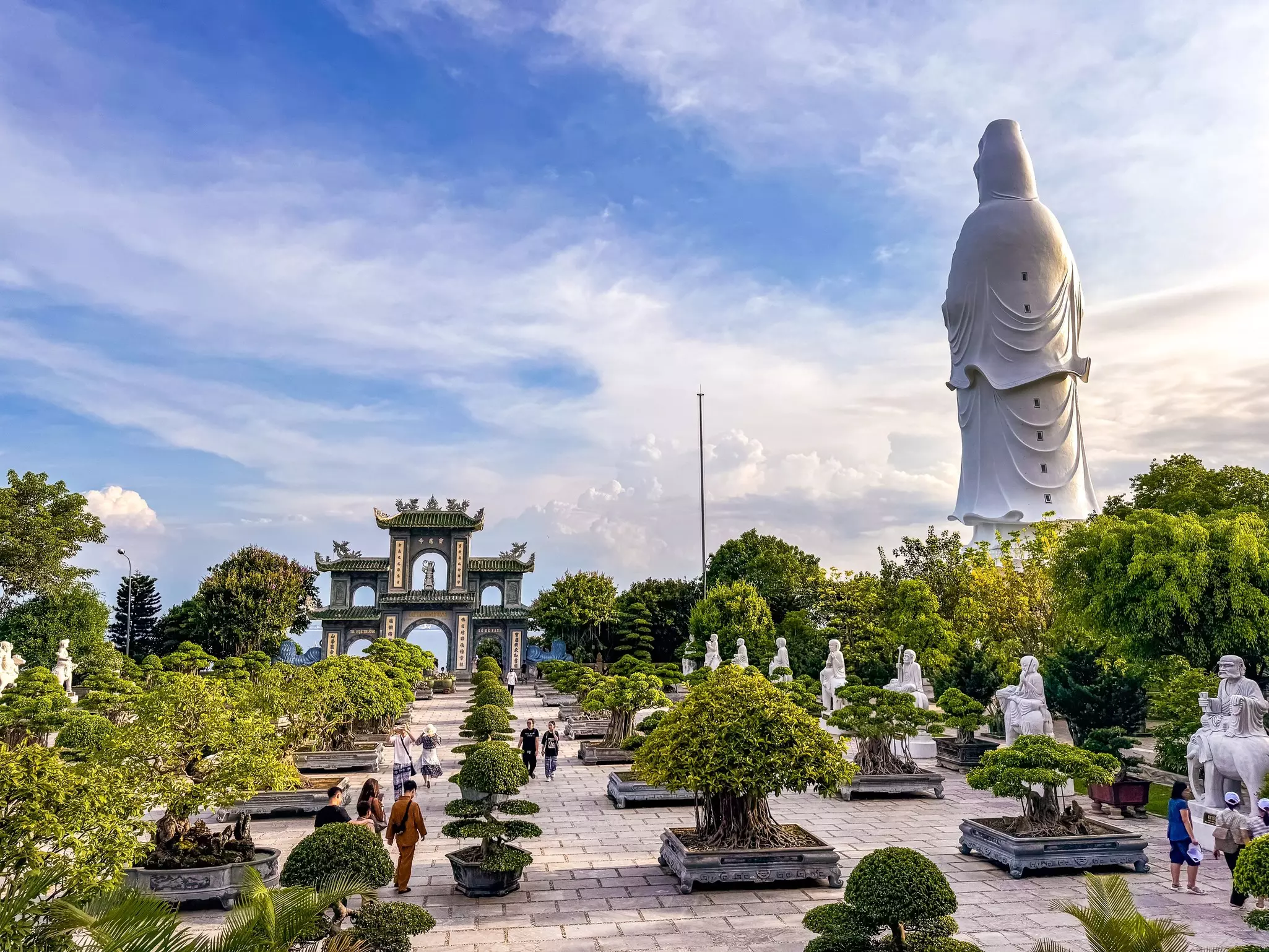 Chua Linh Ung pagoda with large plants in the foreground and some visitors