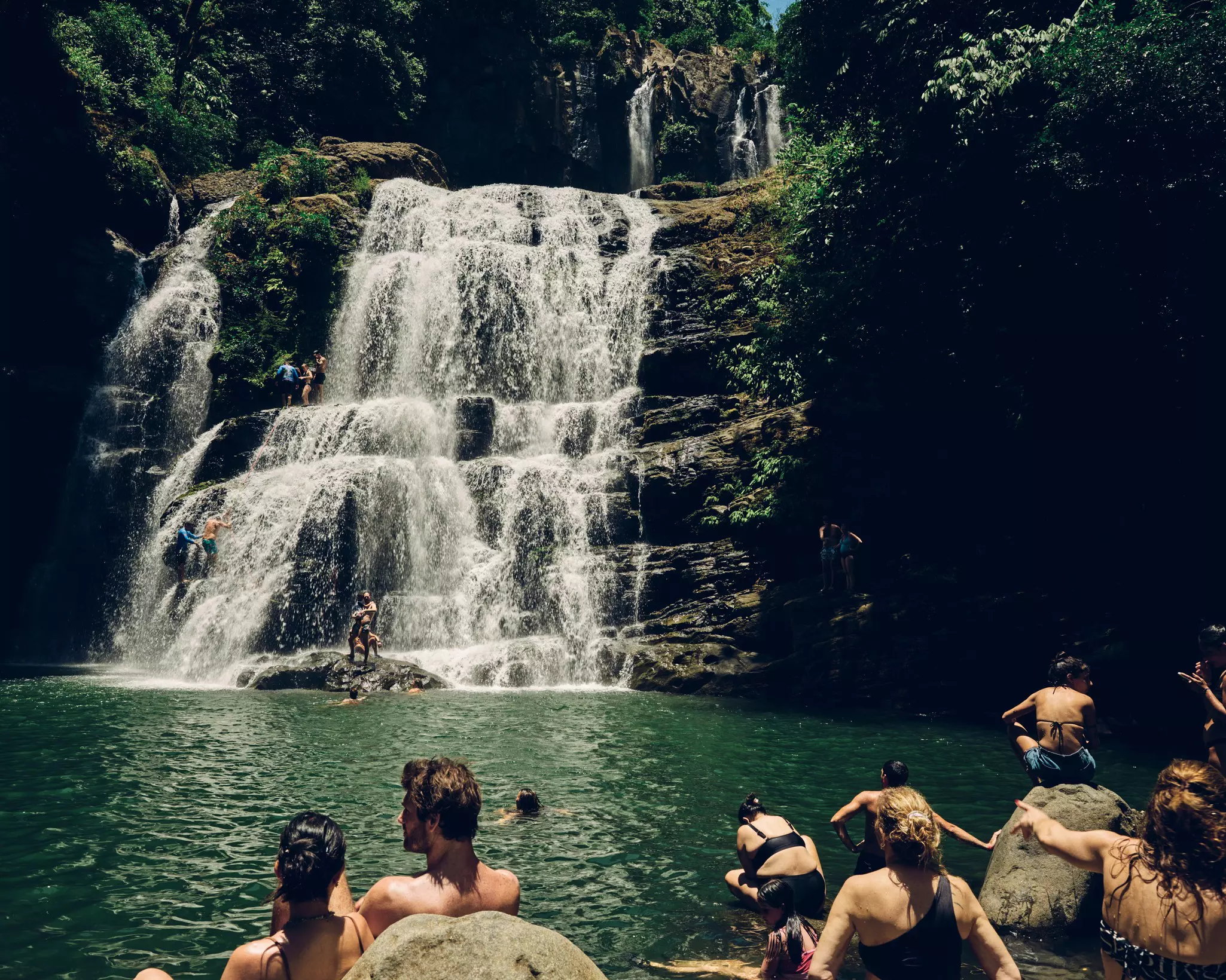 Tourists enjoying Nauyaca Waterfalls in Costa Rica