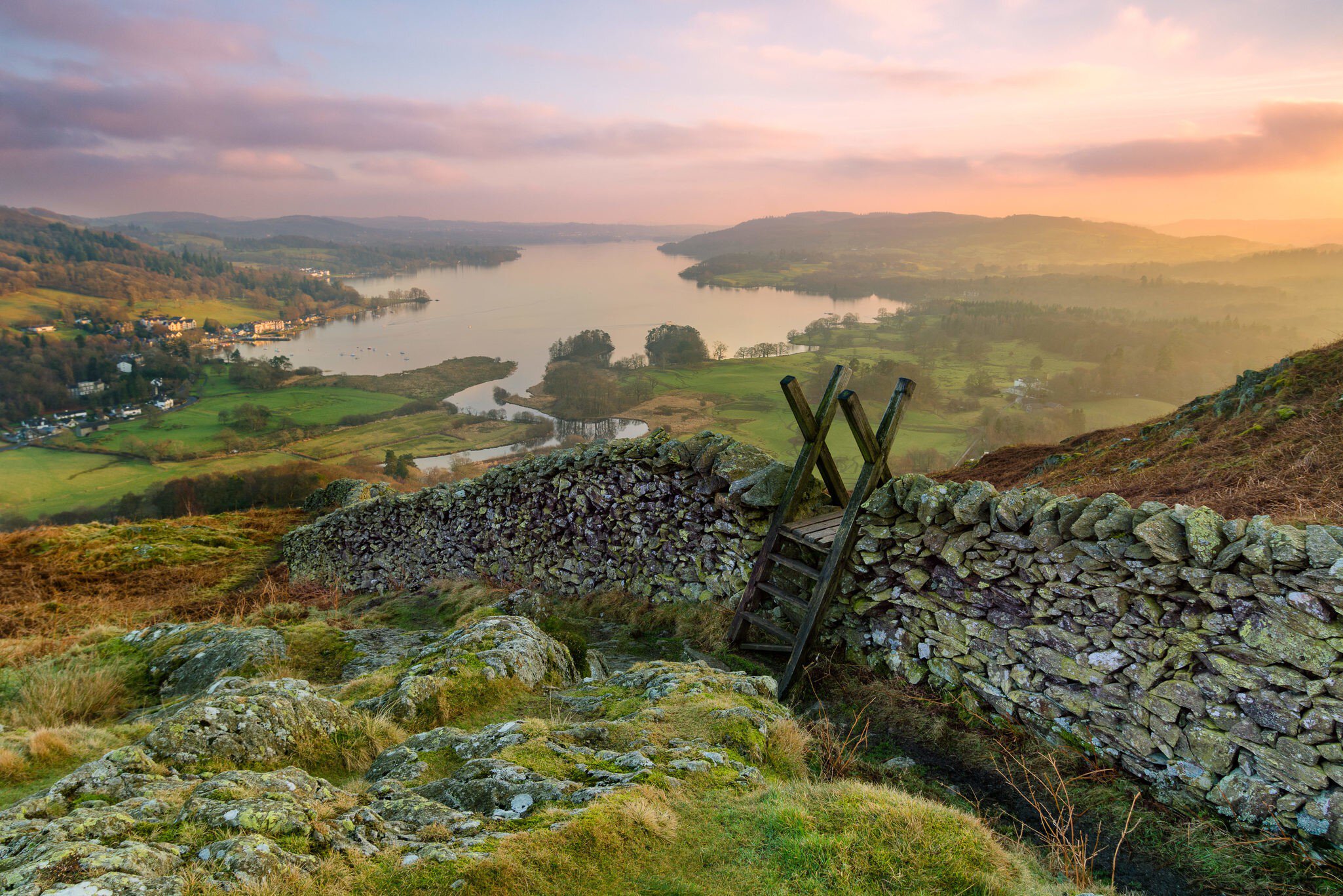 Sunset over Windermere in the Lake District with a stile and stone wall in the foreground.
562350370
uk, hill, stone, stile, vibrant, travel, view, rock, valley, horizon, walking, light, lake, dusk, sun, countryside, district, crag, britain, wall, england, english, high, blue, winter, mountain, sunset, outdoors, sky, scenic, golden, scene, wooden, beautiful, background, peak, water, nature, environment, europe, landscape, national park, loughrigg, cumbria, windermere