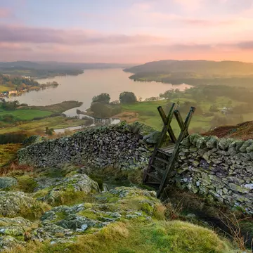 Sunset over Windermere in the Lake District with a stile and stone wall in the foreground.
562350370
uk, hill, stone, stile, vibrant, travel, view, rock, valley, horizon, walking, light, lake, dusk, sun, countryside, district, crag, britain, wall, england, english, high, blue, winter, mountain, sunset, outdoors, sky, scenic, golden, scene, wooden, beautiful, background, peak, water, nature, environment, europe, landscape, national park, loughrigg, cumbria, windermere