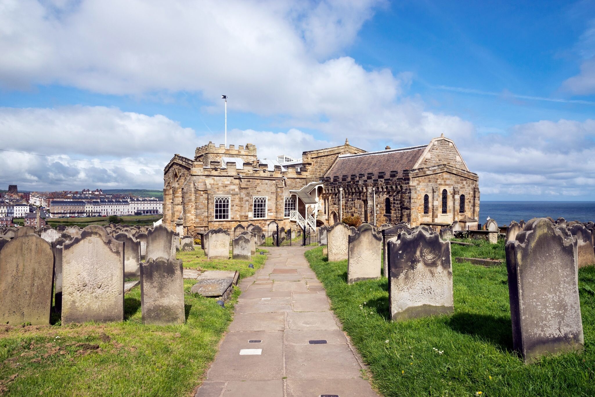 View of Whitby from St Mary's church, North Yorkshire, England - stock photo

Path in the graveyard beside this historic church on the cliff above the town of Whitby. A busy tourist destination with many attractions and a connection to the novel '...