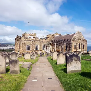 View of Whitby from St Mary's church, North Yorkshire, England - stock photo

Path in the graveyard beside this historic church on the cliff above the town of Whitby. A busy tourist destination with many attractions and a connection to the novel '...