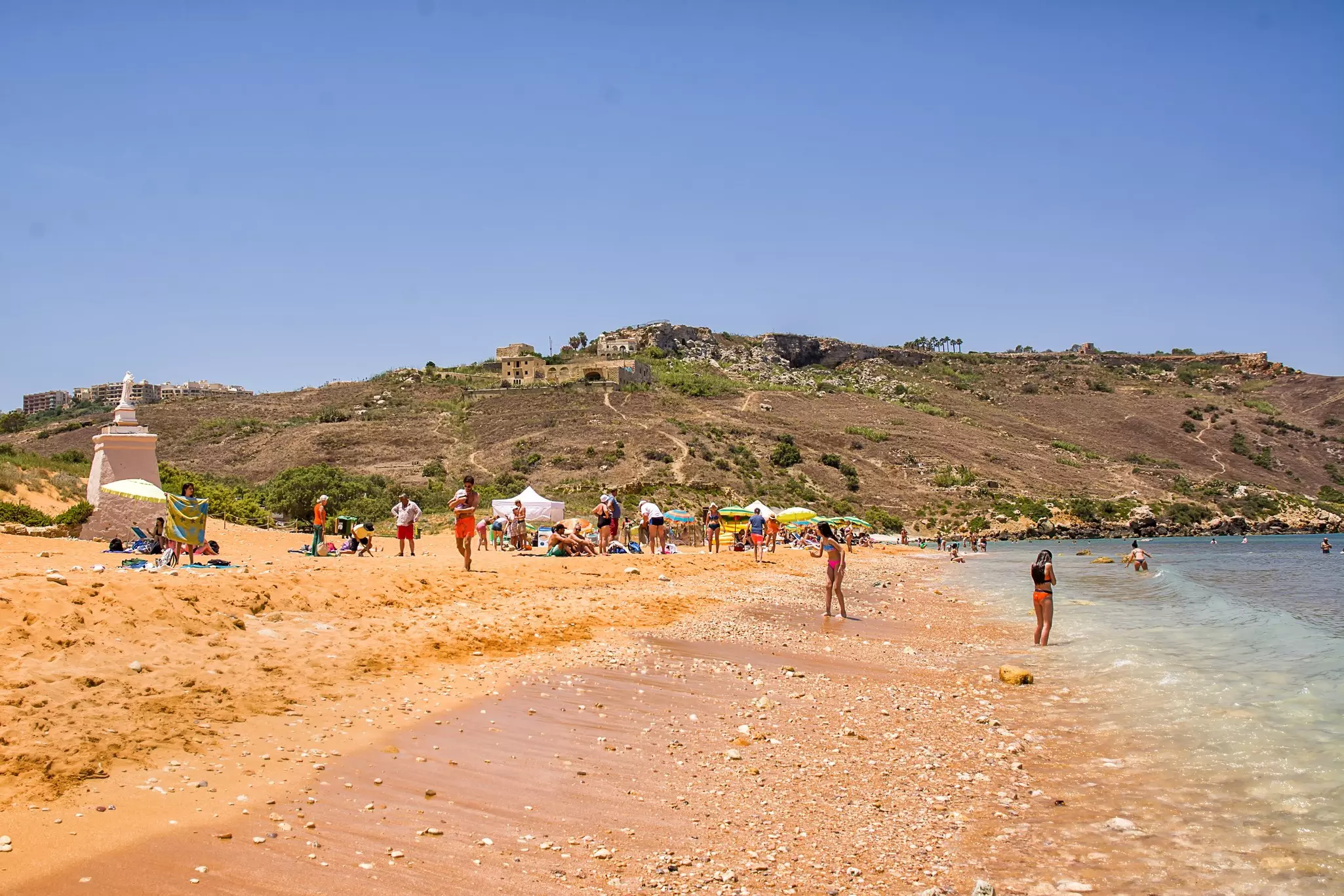 Ramla beach in Gozo (Malta) with tourists and bathers