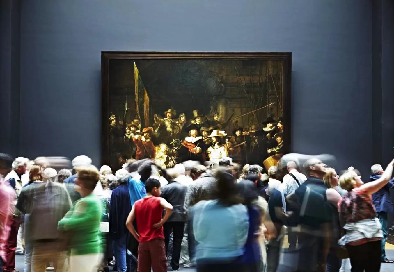 People looking at Rembrandt's Night Watch painting at Rijksmuseum