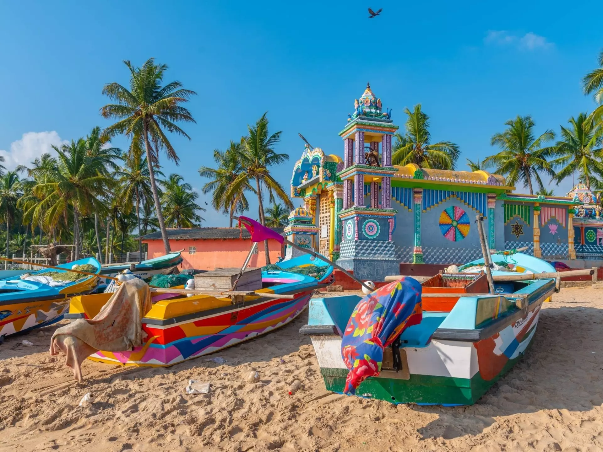 Bala Murugan Temple at Trincomalee, Sri Lanka with colourful boats in foreground.