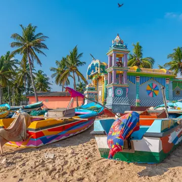 Bala Murugan Temple at Trincomalee, Sri Lanka with colourful boats in foreground.