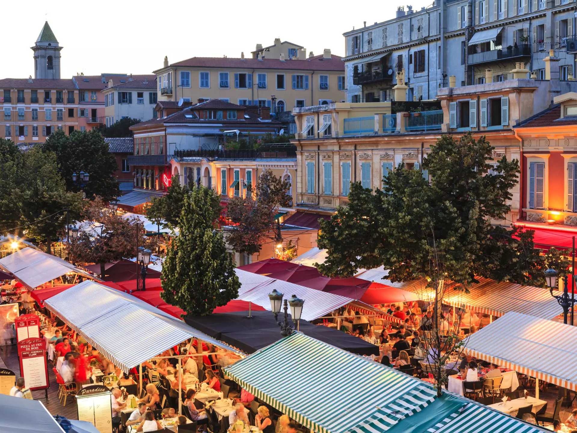 Open-air restaurants with table packed with guests in the French city of Nice