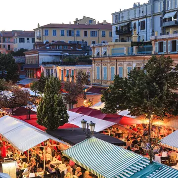Open-air restaurants with table packed with guests in the French city of Nice