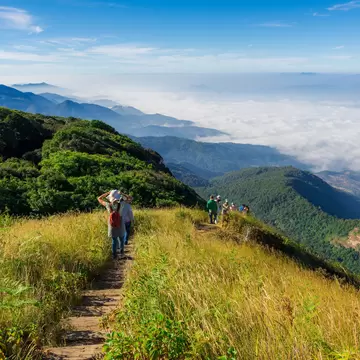 Tourists walking along a trail in Doi Inthanon National Park on a sunny day in Chiang Mai, Thailand.