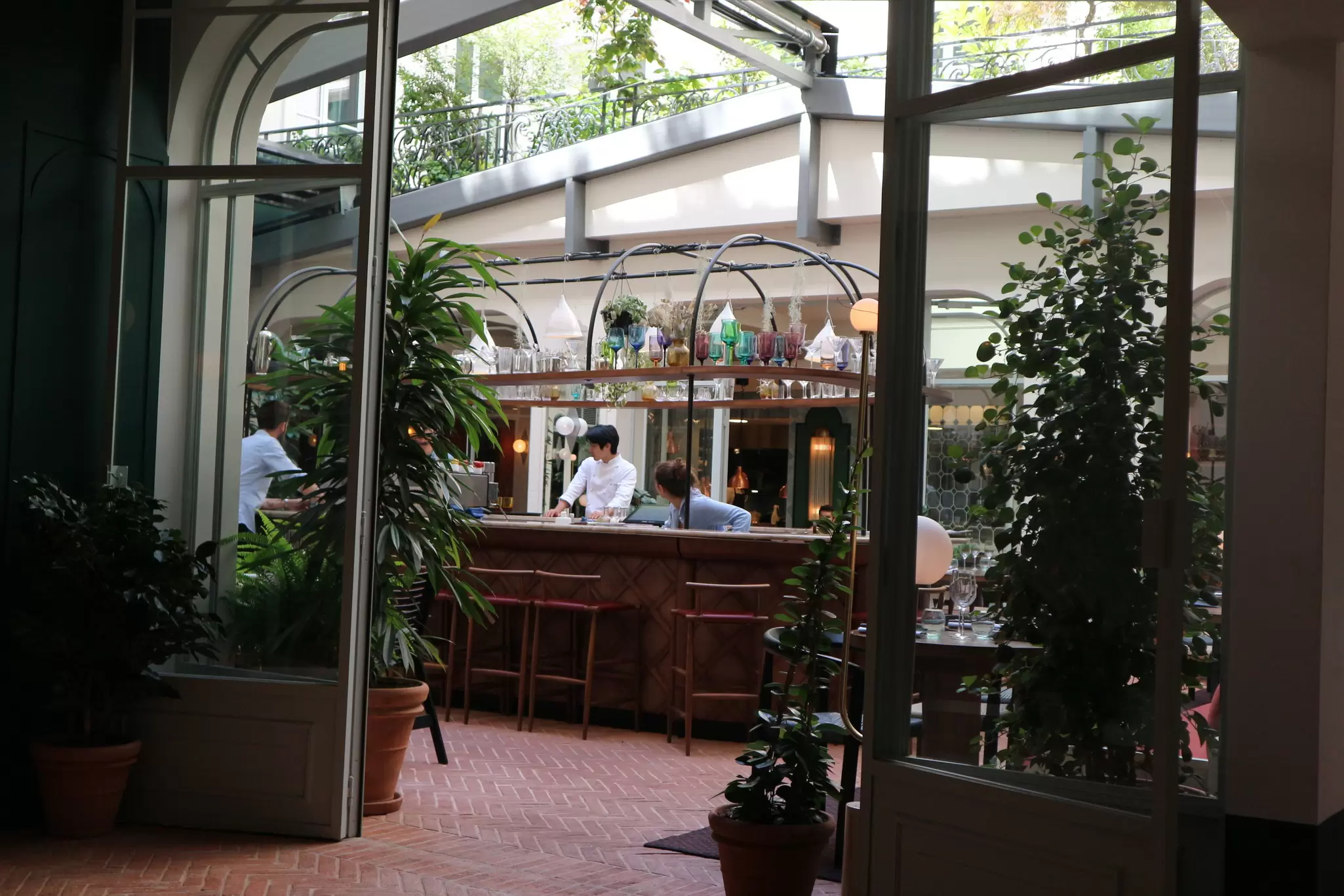 A round bar in a courtyard surrounded by plants