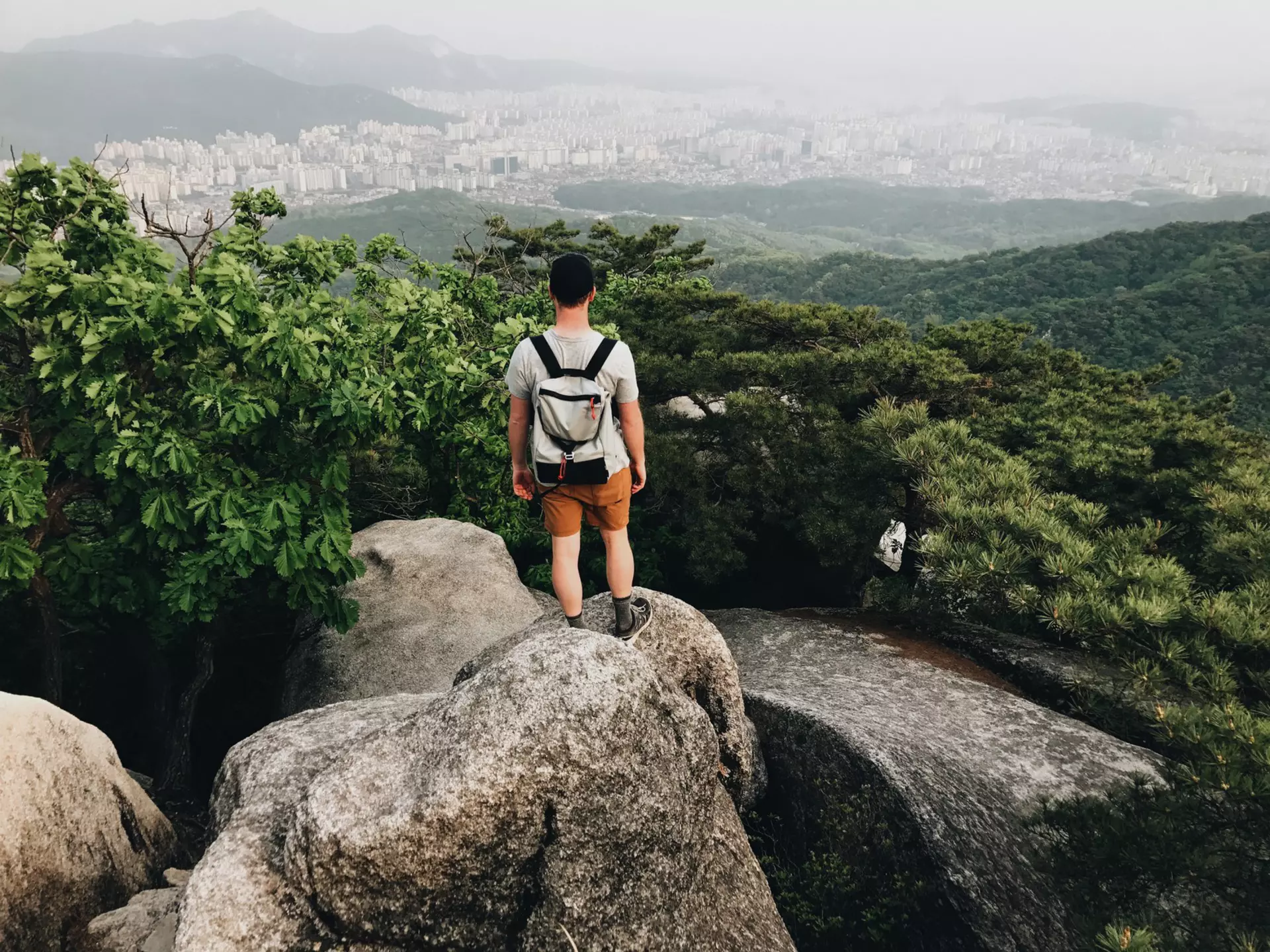 Young Man Hiking In Bukhansan National Park View Looking Out To The City Of Seoul South Korea,,