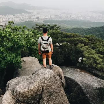 Young Man Hiking In Bukhansan National Park View Looking Out To The City Of Seoul South Korea,,