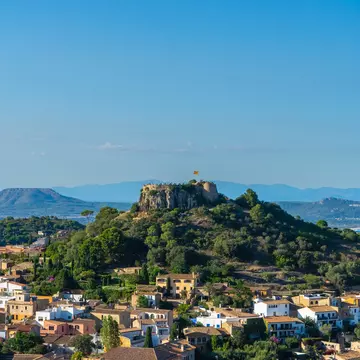 View of Castell de Begur on top of a hill above the village of Begur in Spain.
