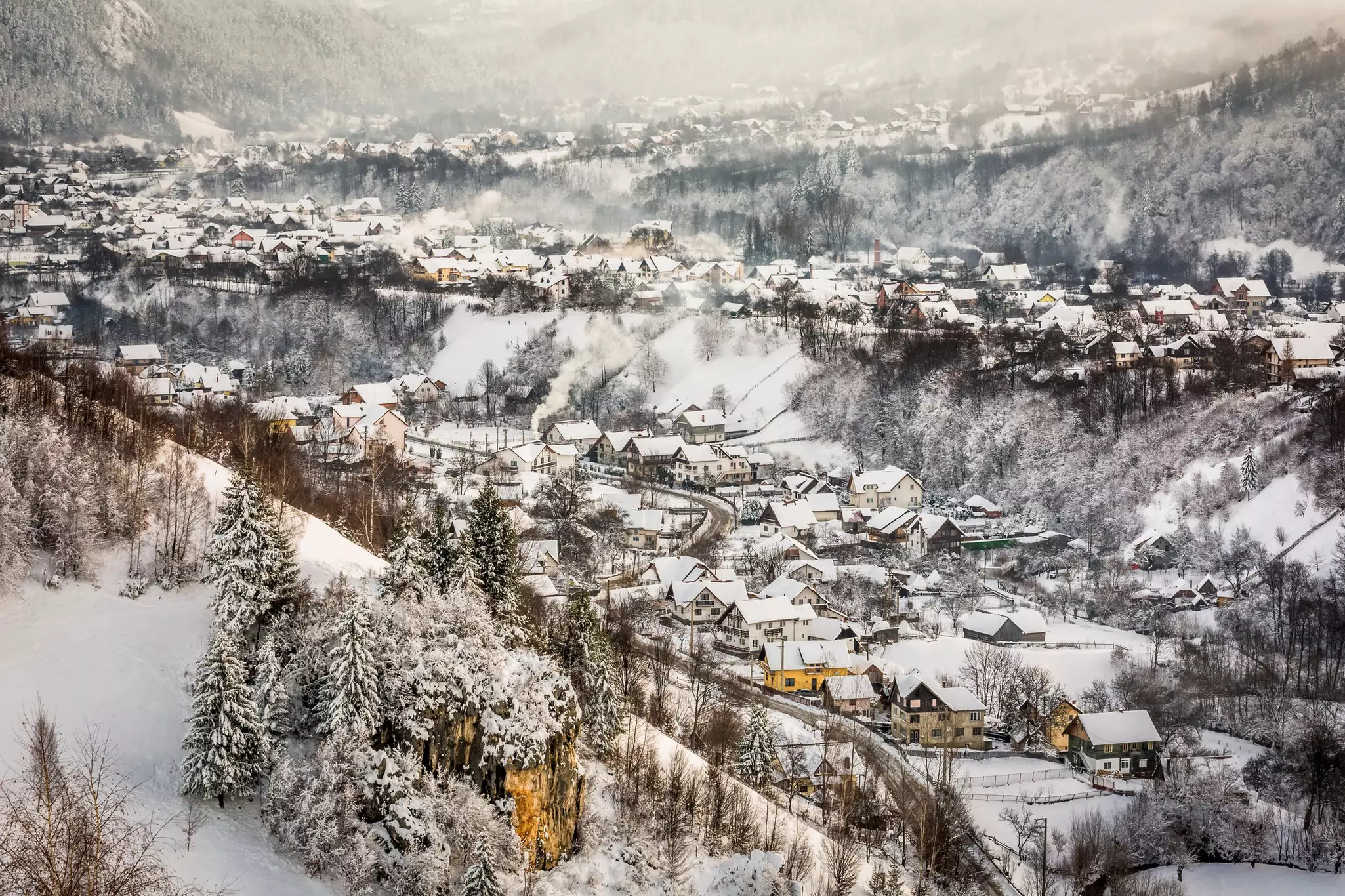 A mountain village covered in a dusting of white snow.