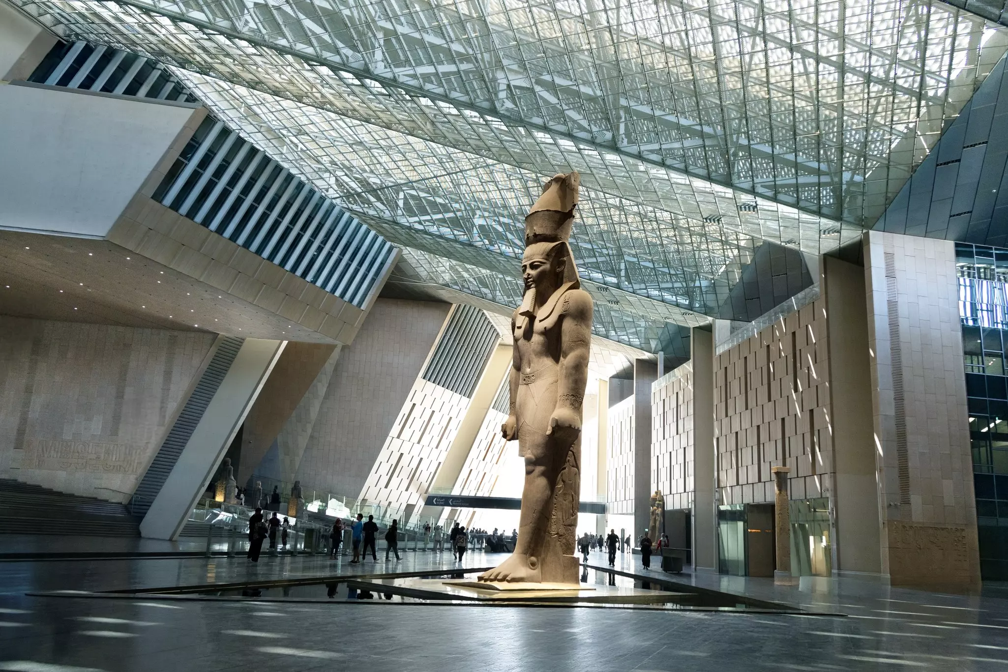 Massive Ancient Egyptian Ramses II Statue Standing Under the Glass Skylight of The Grand Egyptian Museum.