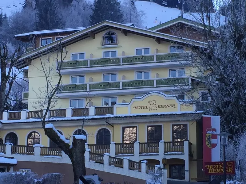 A yellow building with a ramp leading to a porch.