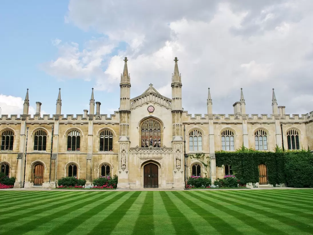 Cambridge, Cambridgeshire, England, U.K. 08/19/2014. Corpus Christi College with its beautiful lawn that rolls down to the River Cam is part of Cambridge University, England.