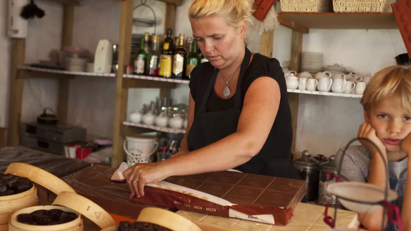 A child stands next to a