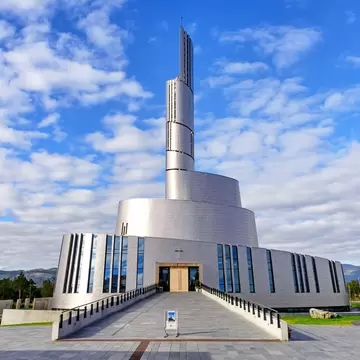 Alta, Norway - August 16, 2016: View of the main entrance side of the Northern Lights Cathedral. This modern church was built in a circular style in 2013; Shutterstock ID 1341159728;