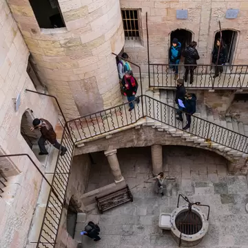 Overhead view of tourists visiting the courtyard of the Chateau d'If, a famous prison which was the settings of Alexandre Dumas novel The Count of Monte Cristo. Marseille, France.