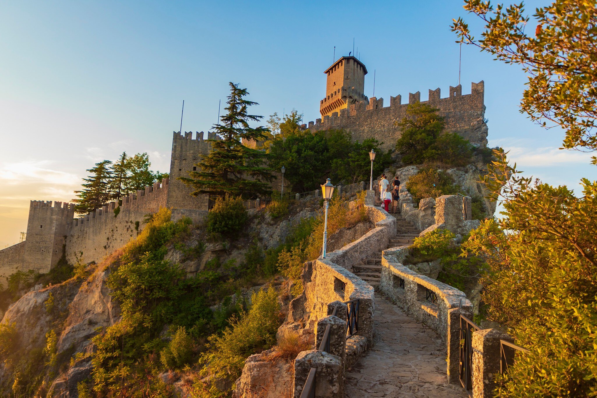 Steps leading up to Guaita Tower (Torre Guaita) at sunset in San Marino, Italy.
