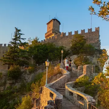 Steps leading up to Guaita Tower (Torre Guaita) at sunset in San Marino, Italy.