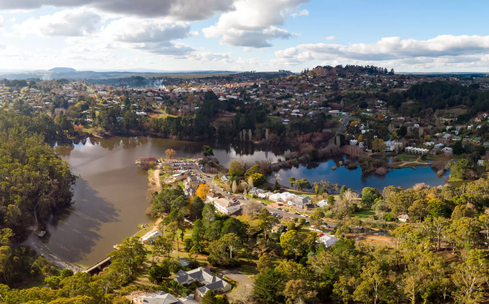 An aerial view of the quaint country town of Daylesford on a winter's day in Victoria, Australia with a large lake in the center overlooked by trees and residential homes.