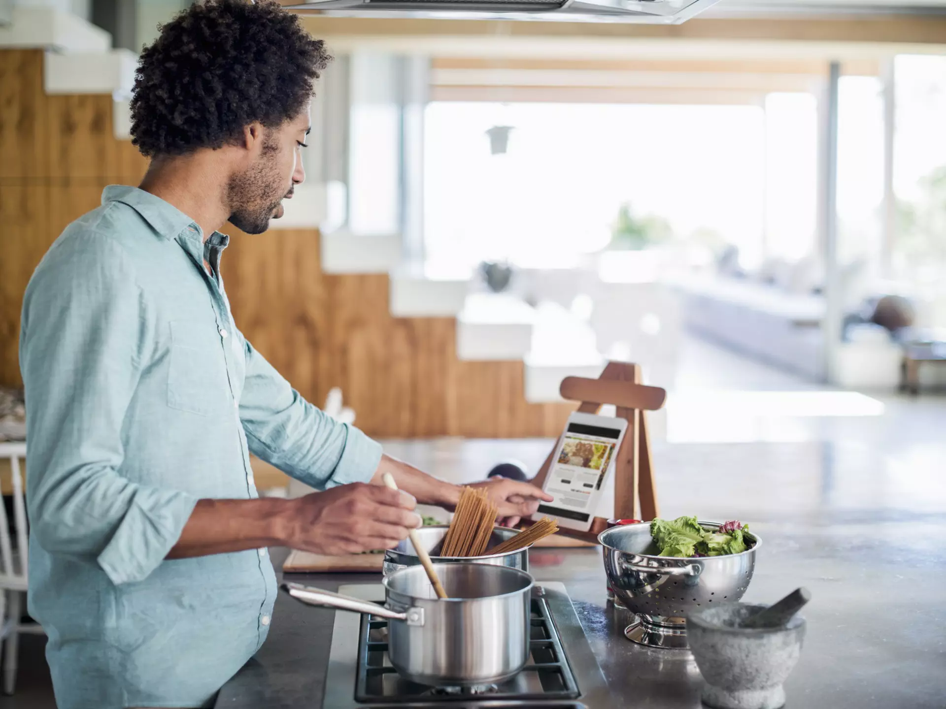 Man cooking in the kitchen while reading a recipe of a digital tablet
483963425
Connection, Portability, Preparation