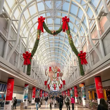 Friends embrace in railroad station at Christmas