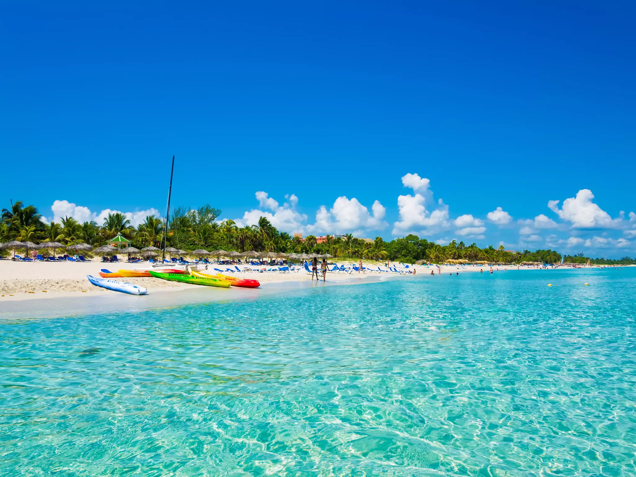 The beautiful beach of Varadero in Cuba with colorful boats and thatched umbrellas (image taken from the sea).