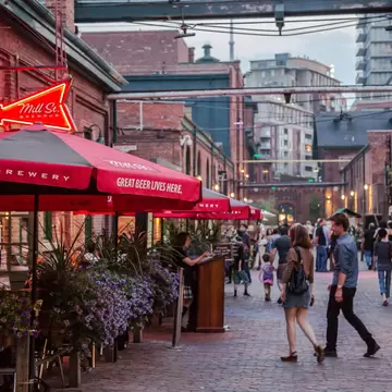 People walk through a neighbourhood in Toronto