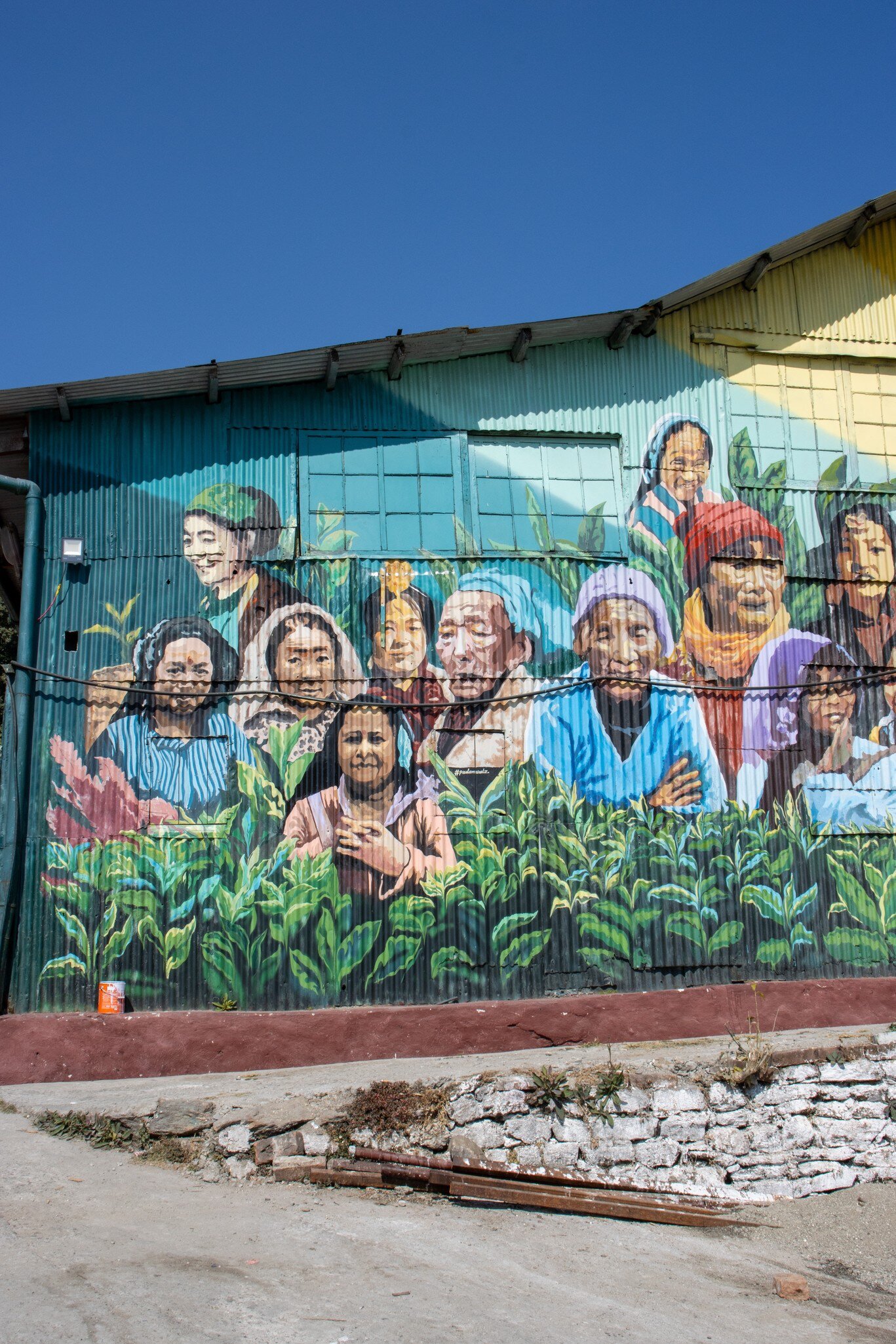 Makaibari Tea Estate Mural and painting on the side of the main processing building in Darjeeling, India.