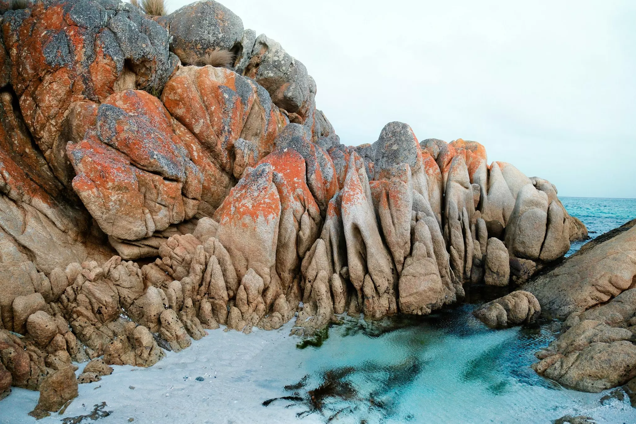 Rocks with red on top and water