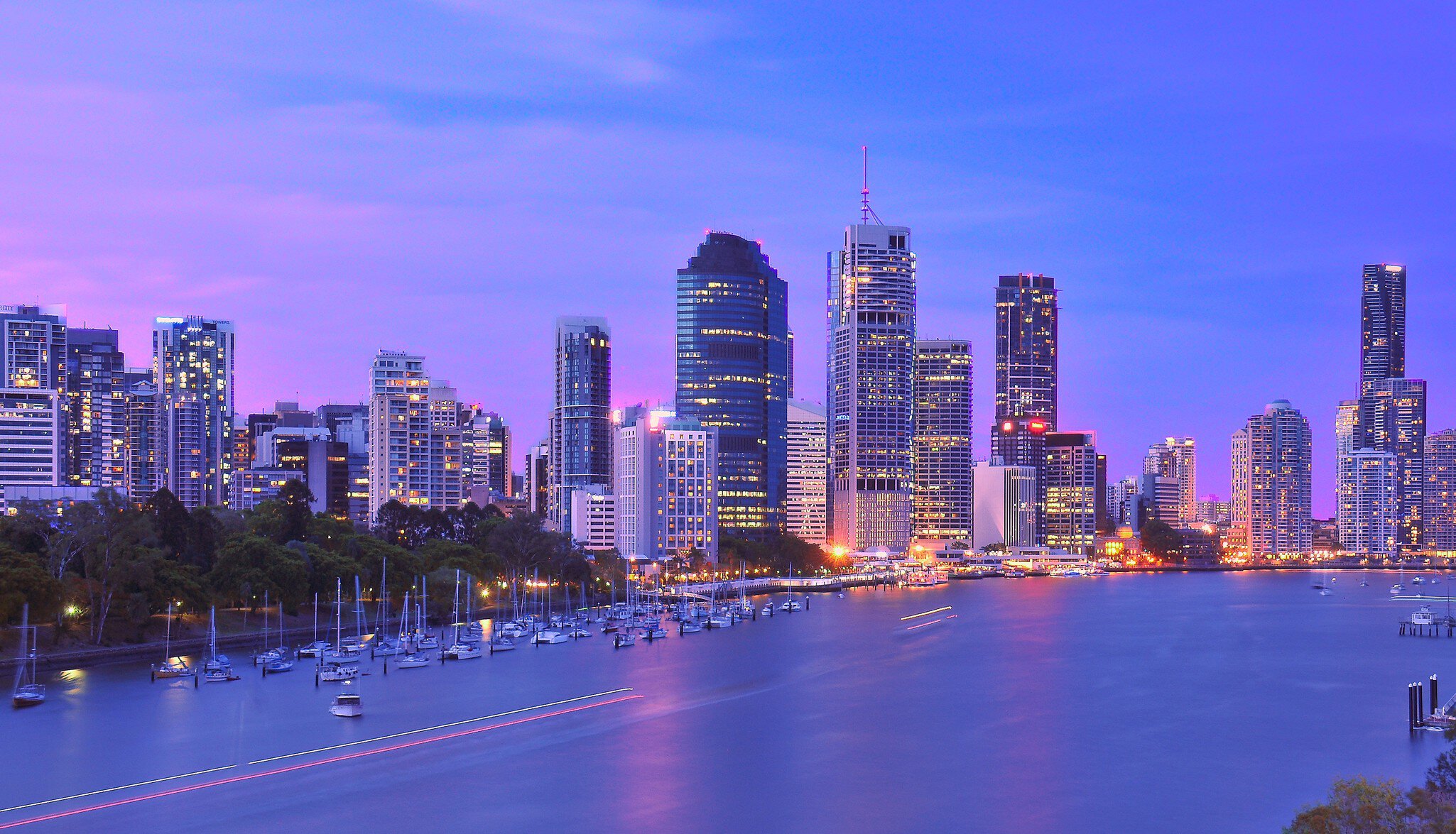 Illuminated waterfront cityscape under purple sky, Brisbane, Australia
