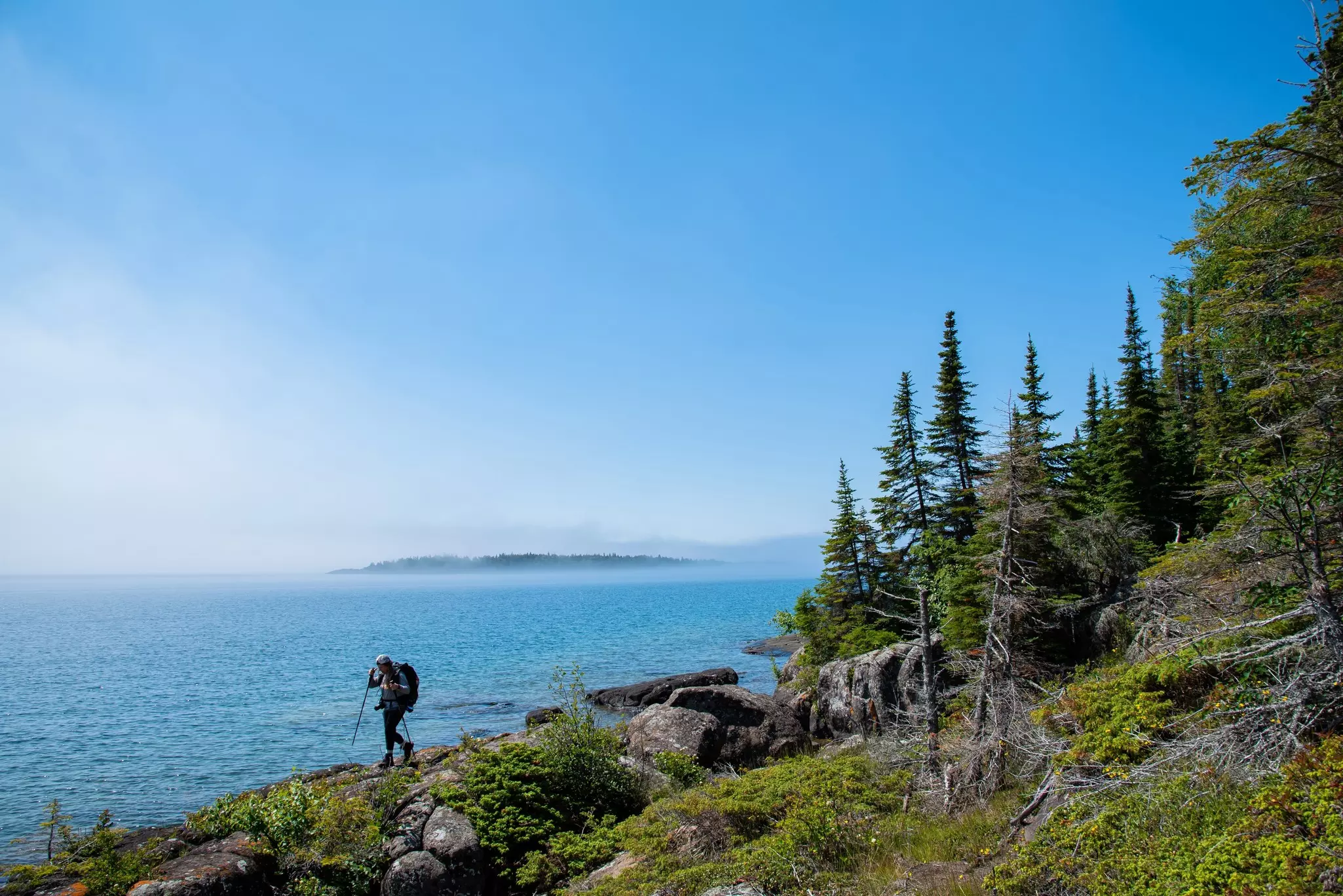 Backpacker hikes across ridge on Isle Royale National Park