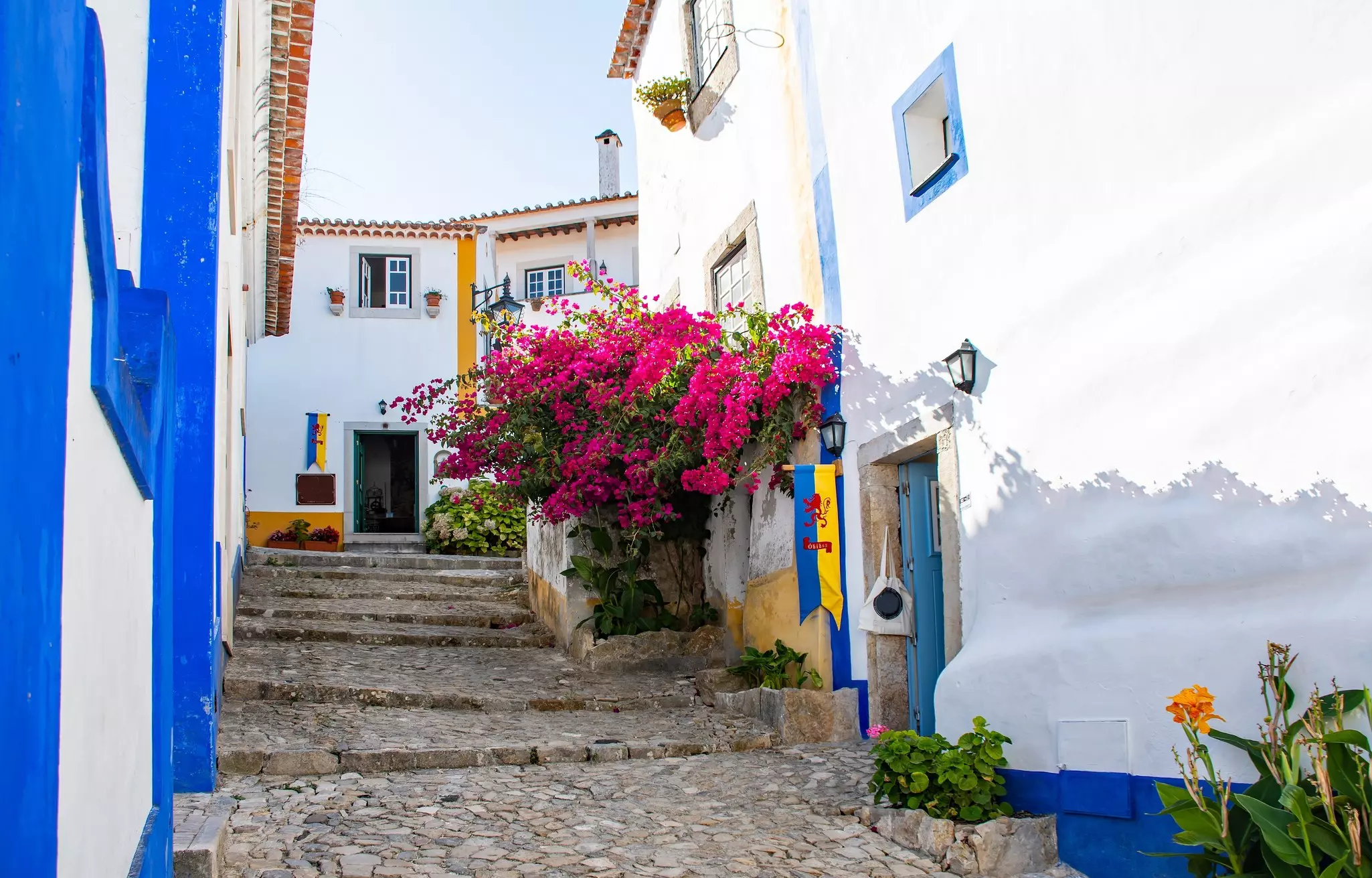 A cobbled alley between white-washed houses in a hilltop town