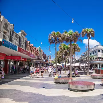 People walking through the shopping area named The Corso in Manly. Sydney, Australia.