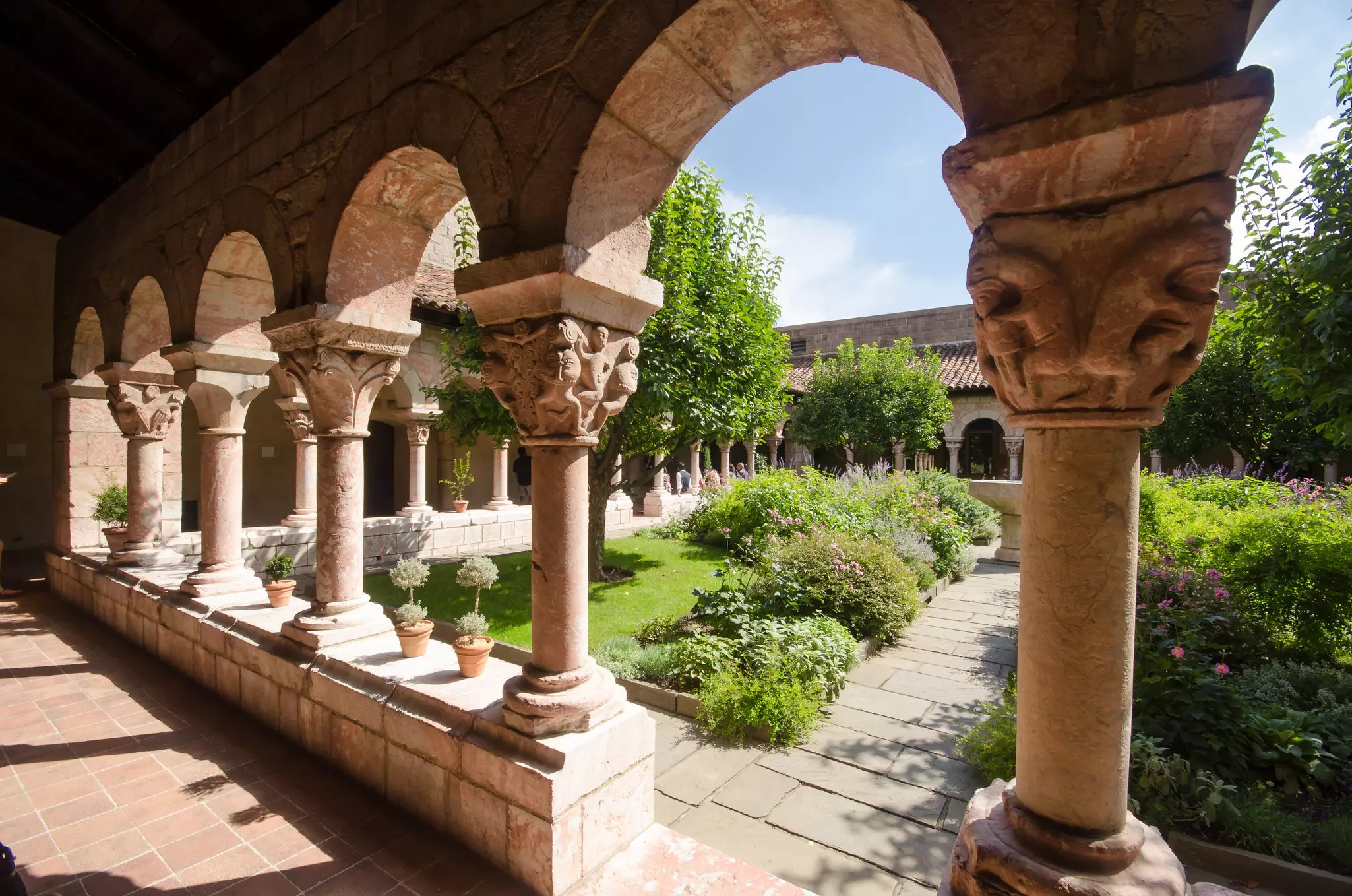A courtyard surrounded by ornate pillars with arches between them