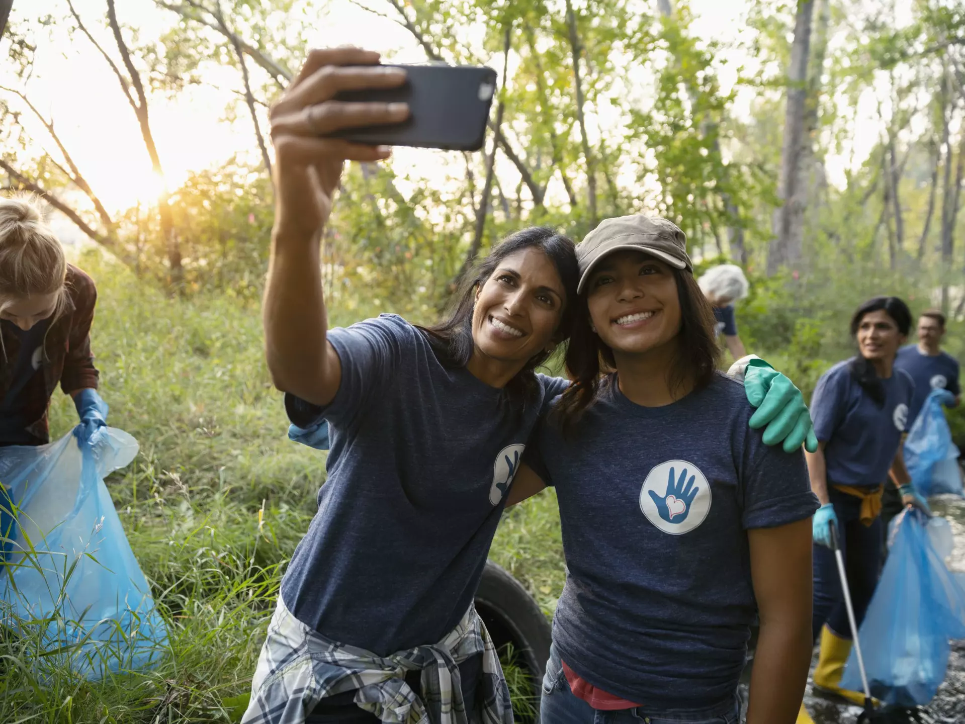 Happy mother and daughter taking selfie and volunteering, cleaning up garbage in park
1051323510
Role Model, Day, EC08, Bonding, 12-13 Years, 45-49 Years, Smart Phone, Mobile Phone, Toothy Smile, Mature Women, Mature Adult, Photographing, Females, North America, Self Portrait, Communication, Standing, Support, Family, Park, Community, Woodland, Responsibility, A Helping Hand, Litter, Portrait, Clean Up, Casual Clothing, Happiness, Women, Photo Messaging, Cheerful, Teamwork, Memories, Daughter, Assistance, Adult, Cleaning, Mixed Race Person, Selfie, Altruism, Photography Themes, Nature, Computer, Social Issues, Mother, Environmental Issues, Childhood, Waist Up, Real People, Family with One Child, Love, Canada, Embracing, Child, Indian Ethnicity, Care, Weekend Activities, Portable Information Device, Dedication, Arms Outstretched, Enjoyment, Looking Up, Incidental People, T-Shirt, Picking Up, Environmental Cleanup, Single Mother, Selective Focus, Wireless Technology, Outdoors, Smiling, Girls, Self Portrait Photography, Two People, Volunteer, Efficiency, Photography, Generosity, Color Image, People, One Parent, Technology, Leaning, Community Outreach, Charity and Relief Work, Lifestyles, Part of a Series, Love - Emotion, Environmentalist, Togetherness, Pre-Adolescent Child, Affectionate, Environmental Conservation, Horizontal, Holding, Garbage, Arm Around, Garbage Bag, Social Responsibility