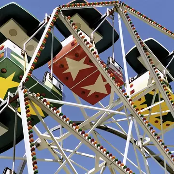 Ferris wheel against the blue sky at amusement park Tivoli Friheden, Aarhus, Denmark.
