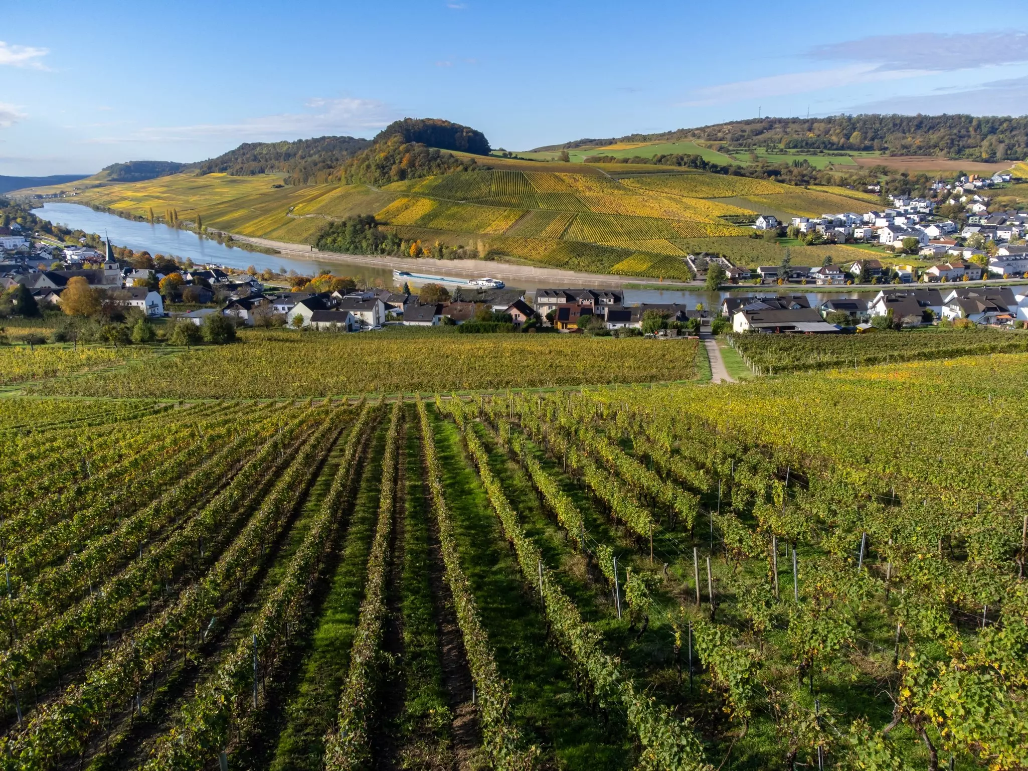 Views across Moselle River to vineyard covered hills in Luxembourg near Grevenmacher.